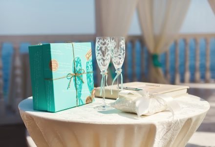 Wedding arches in the Tiffany color on the beach. Island. The ocean. Ceremony. Table. Registration. The champagne glasses.